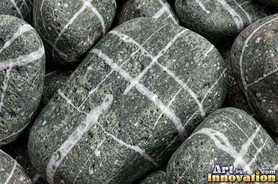 Smooth river pebbles packed tightly in salt and pepper tones