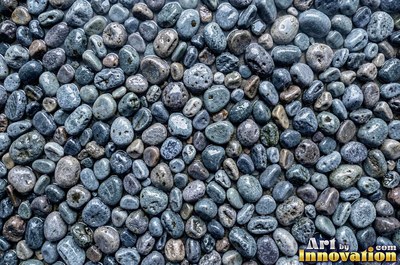 Smooth river pebbles packed tightly in salt and pepper tones