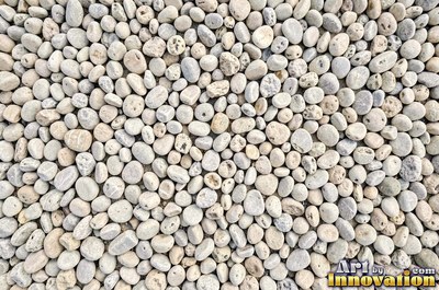 Smooth river pebbles packed tightly in salt and pepper tones