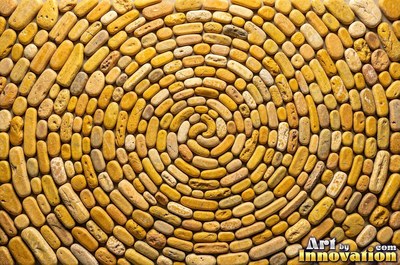Flat skimming stones overlapping like scales in warm beige
