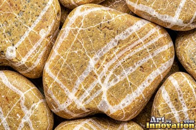 Flat skimming stones overlapping like scales in warm beige