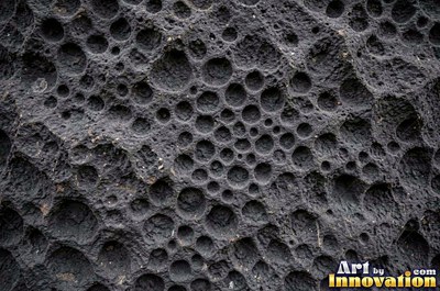 Honeycomb weathering pitted into a rust red sandstone face