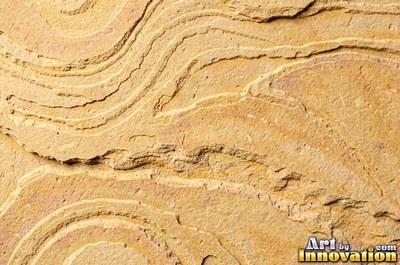 Sandstone with fossil ripple marks across it in sandy tan