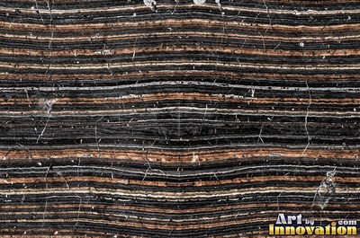 Stratified sedimentary rock in thin bands of sandy tan
