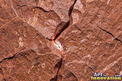 Cleft slate surface with natural ripples and ridges in near black