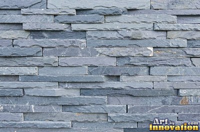 Dry stacked stone wall of flat blue gray slate pieces