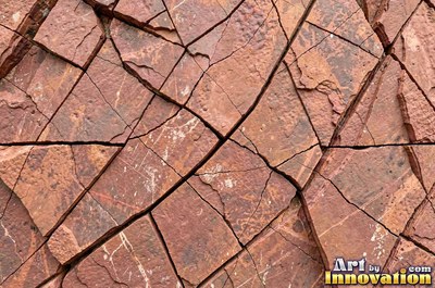 Cleft slate surface with natural ripples and ridges in near black
