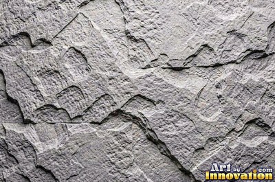 Cleft slate surface with natural ripples and ridges in near black