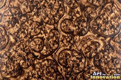 Burl figure glowing with chatoyant shimmer under lacquer