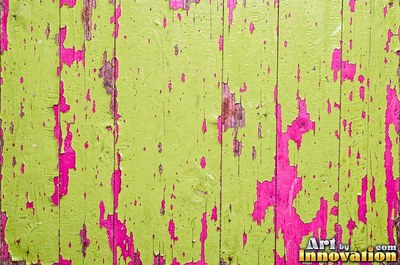 Peeling emerald paint curling off a wooden door in long flakes
