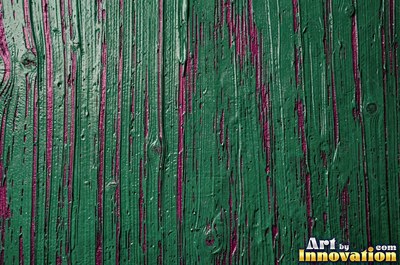 Peeling emerald paint curling off a wooden door in long flakes