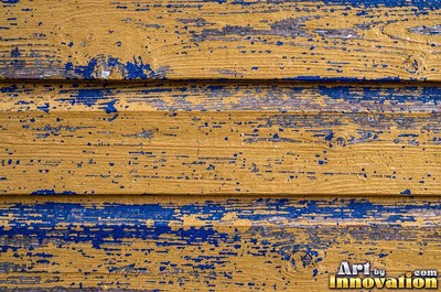 Layers of old royal blue paint sanded back in patches like a map