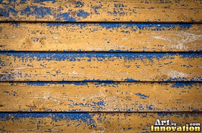 Dry brushed violet paint streaked thin over rough sawn wood