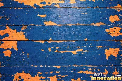 Layers of old royal blue paint sanded back in patches like a map