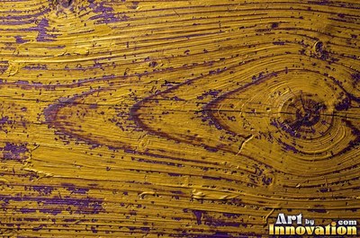 Layers of old royal blue paint sanded back in patches like a map