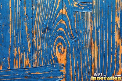 Dry brushed violet paint streaked thin over rough sawn wood