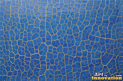 Layers of old royal blue paint sanded back in patches like a map