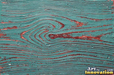 Peeling emerald paint curling off a wooden door in long flakes
