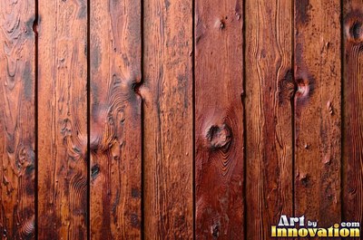 Rough sawn timber boards with faint saw marks under a dark walnut stain