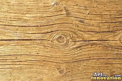 Old barn siding with peeling layers, splits and worn knots