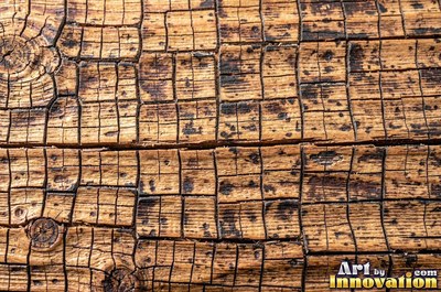 Rough hewn beams with axe marks and dark age cracks in cedar orange