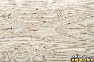 Old barn siding with peeling layers, splits and worn knots