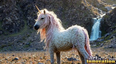 Standing in a rocky valley, a curly-coated bright white unicorn looks past a waterfall