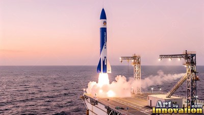 On a sea platform, a blue and white rocket launches with white smoke