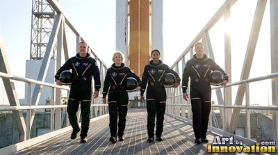 Walking along an open bridge, four astronauts in dark suits carry their helmets in bright sunlight