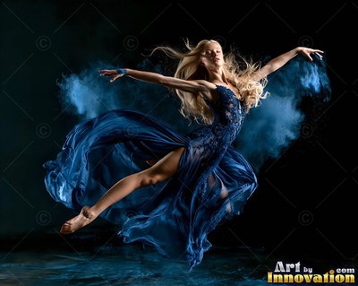 Blonde woman leaping in a blue dress with blue powder