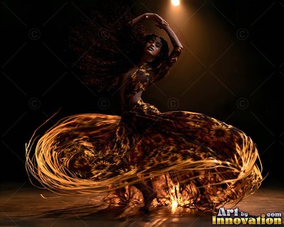 A woman spins in a wide dress with golden fringes trailing in a spotlight