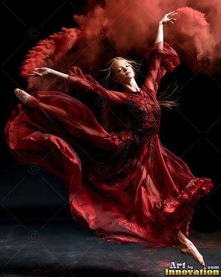A woman jumps in a flowing red gown surrounded by clouds of dark crimson powder