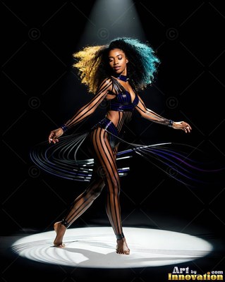 A woman steps forward on a dark stage beneath a bright spotlight