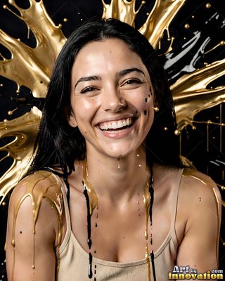 Against a dark studio backdrop, a grinning woman covered in splashes of gold paint