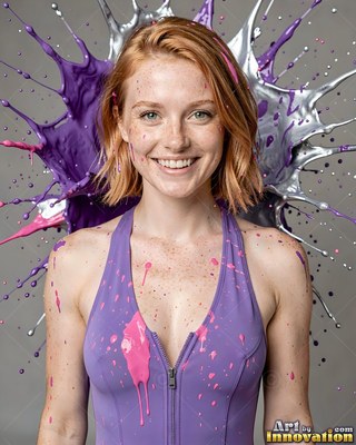Facing forward in a gray studio, a smiling woman wears a purple swimsuit splashed with paint