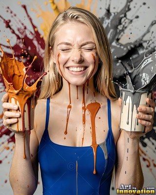 In a studio, a laughing blonde woman holds cups splashing orange and gray paint