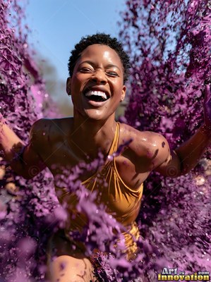 Laughing outdoors, a woman in a yellow top is splashed with purple paint
