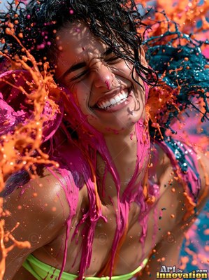 Outdoors in bright sun, a laughing woman gets hit with pink and orange paint