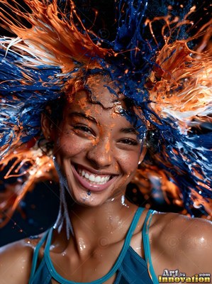 Teal straps over her shoulders, a grinning woman covered in splashes of blue and orange paint in a dark studio