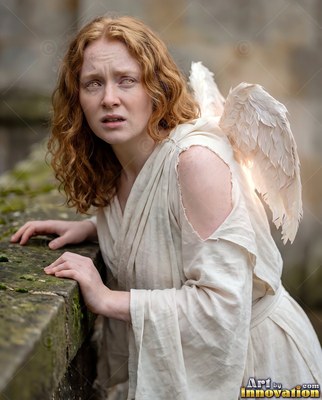A red-haired woman with small feathered wings leans on a stone ledge in soft daylight