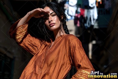 A woman at the edge of a Giza spice market, heaped paprika and cumin in the stalls and warm bounce light off the sandstone walls