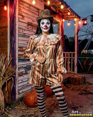 Woman in clown makeup and striped clothes at a fair