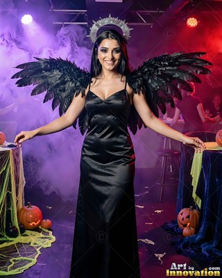Grinning woman dressed as a dark angel with black wings