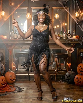 Dancing near carved pumpkins, a grinning woman has on a black flapper dress in a warm bar