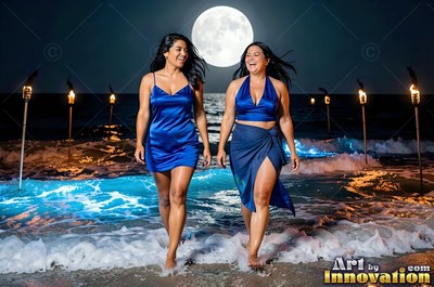 On a moonlit beach, two happy women in blue silk outfits walk through the surf