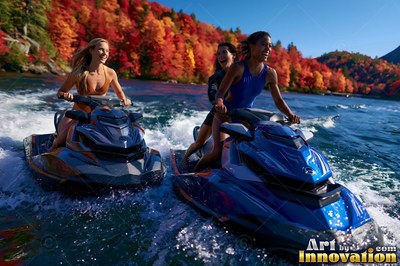 Three smiling women ride blue and gray jet skis on water past red fall trees