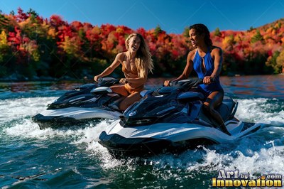 Riding jet skis, two smiling women in swimsuits speed across a lake lined with red trees