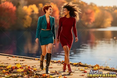 Walking along a wooden dock, two women smile together in autumn sunlight