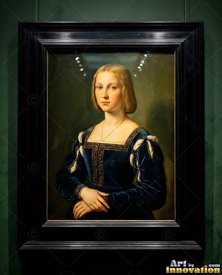 A blonde woman in a dark blue velvet dress stands with her hands folded in a black frame