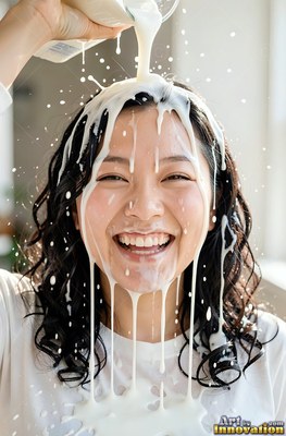 Facing forward by a bright window, a woman in laughter ends up white milk poured over her hair
